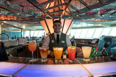 Crew member smiling at the bar